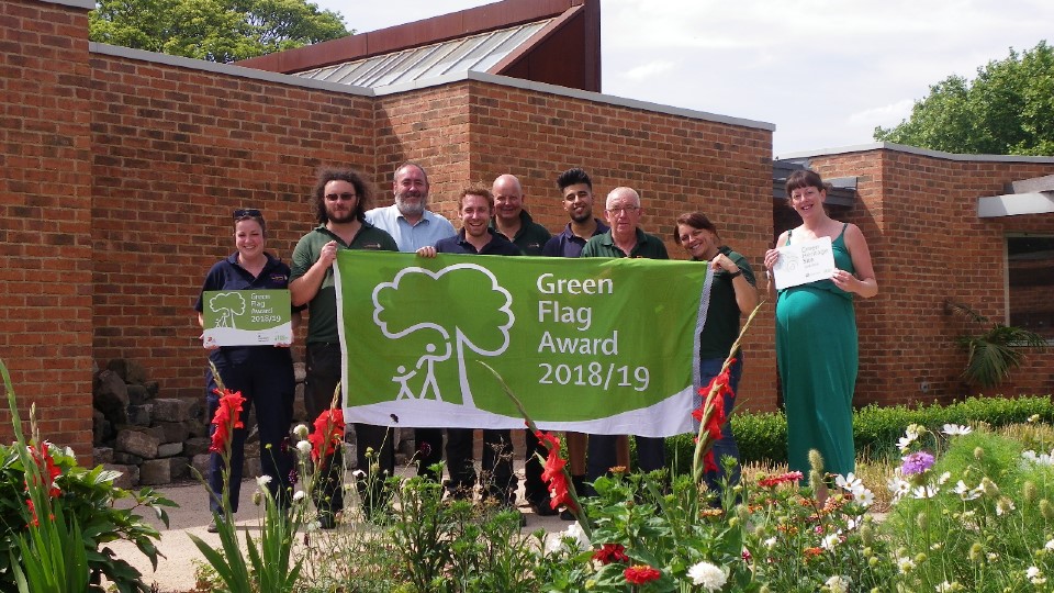 Staff at Clifton Park, outside the Garden House with the Green Flag Award