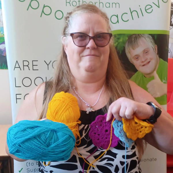 Woman holding knitted euro flower