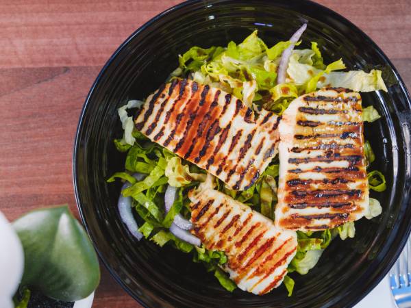 Plate of grilled food with salad