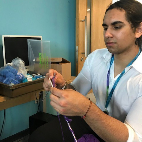 Man knitting a flower